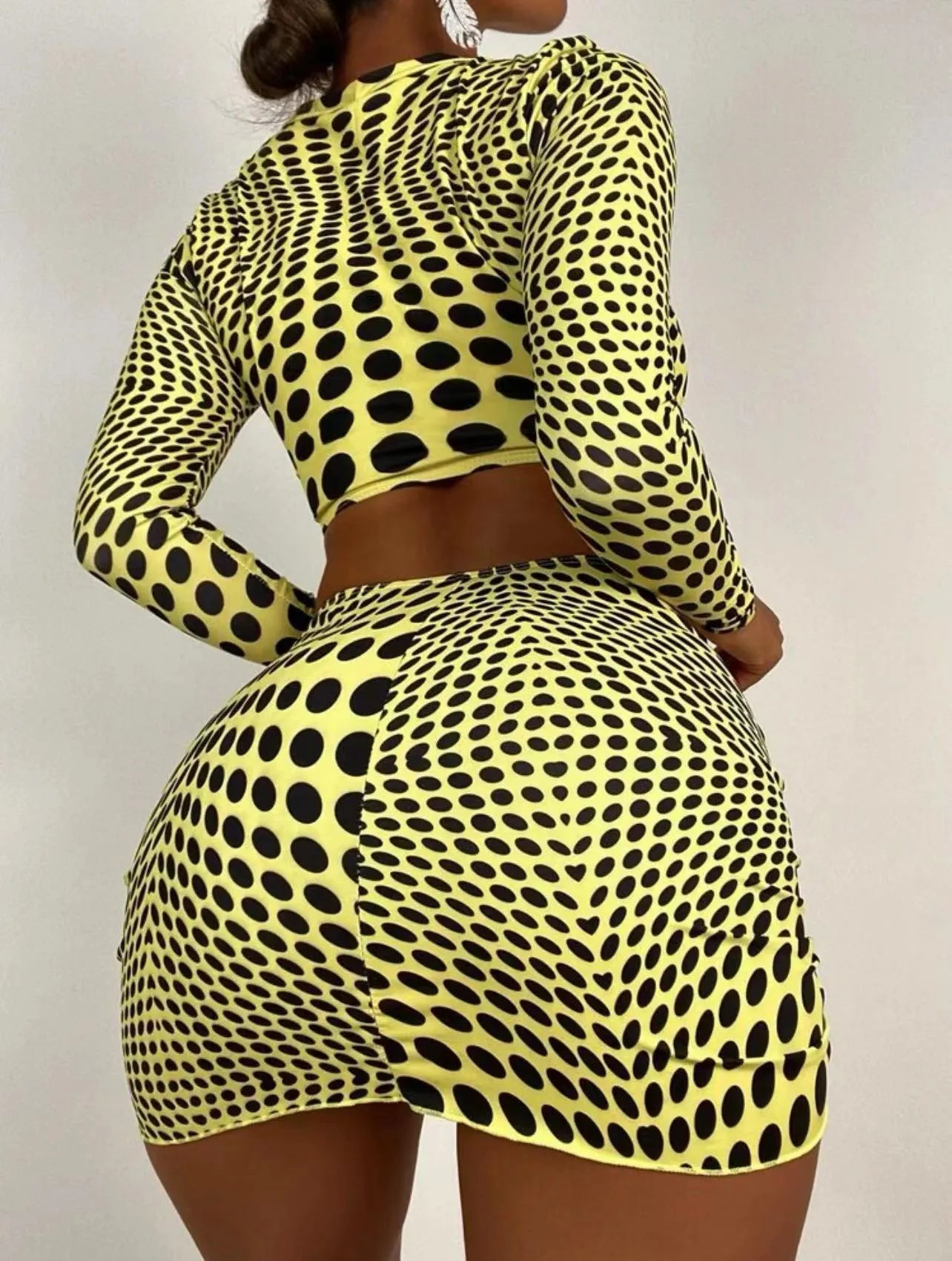 Green and yellow polka dot women's swimsuit three-piece set with top, skirt, and bra.