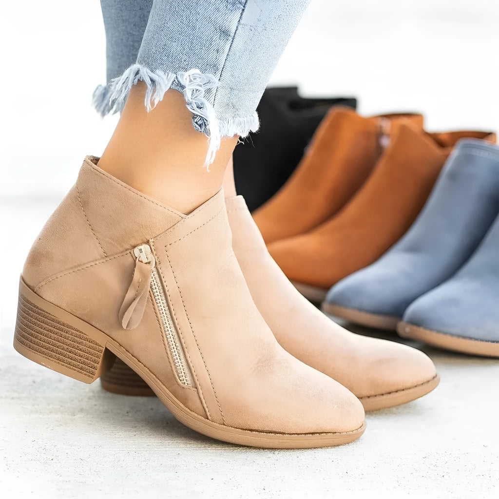 Blue women's suede ankle boots with a chunky heel and a side zip closure on a white background.