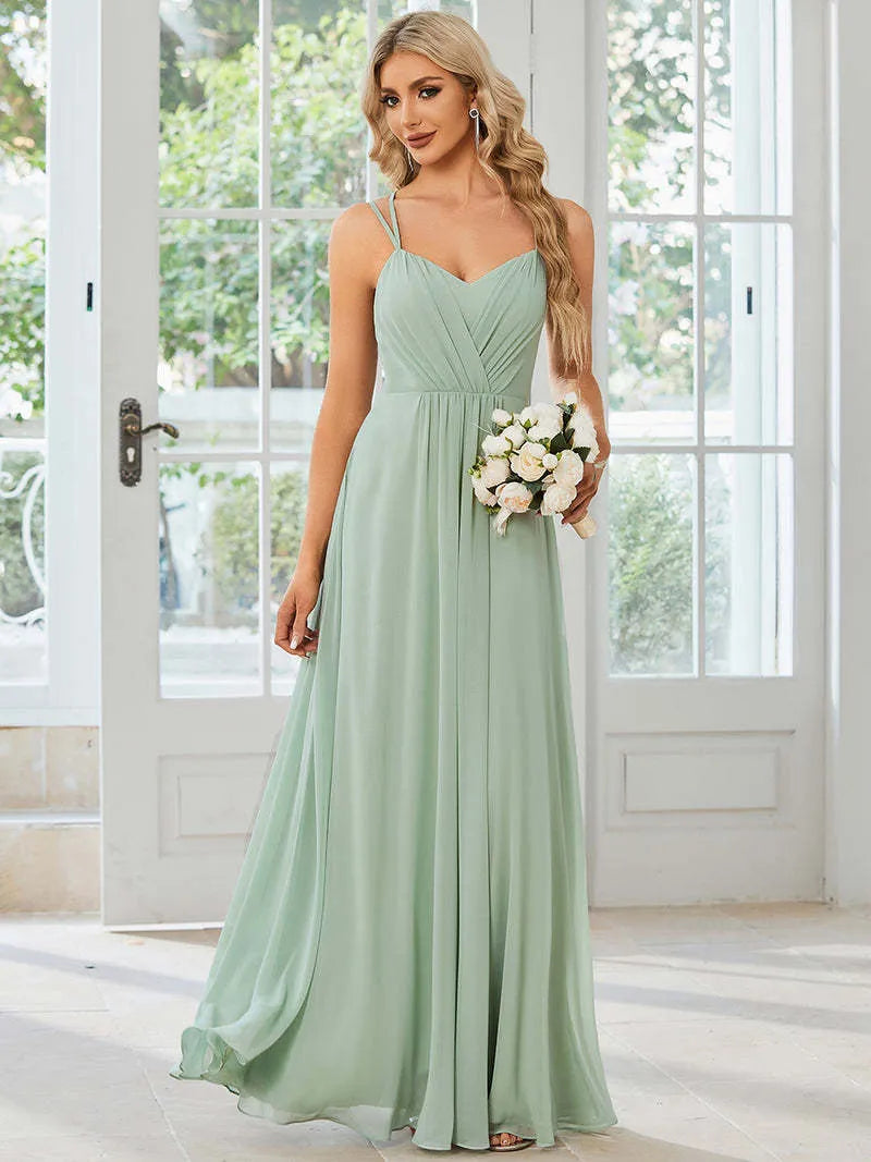 Women's long pleated sleeveless A-line dress in light green, shown on a mannequin.