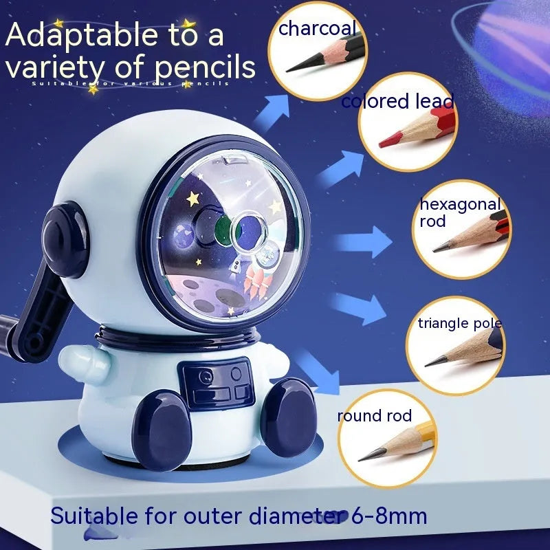 Blue and pink cartoon astronaut model manual pencil sharpener for children on a desk.