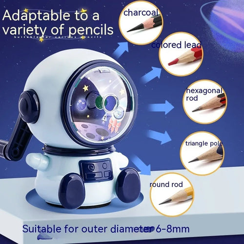 Blue and pink cartoon astronaut model manual pencil sharpener for children on a desk.