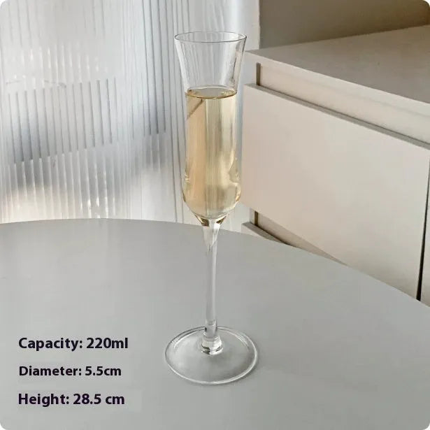 A single clear French goblet champagne glass on a table.