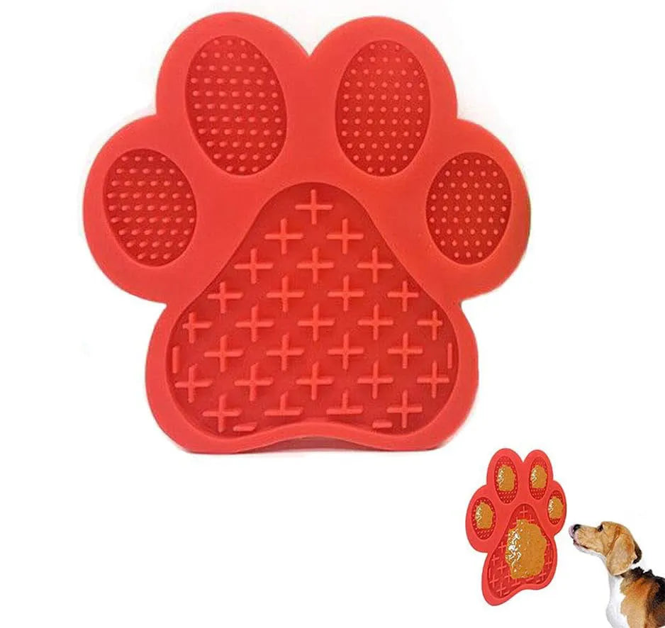 Blue silicone dog licking mat with bone texture and suction cups on the back, placed on a tiled wall.