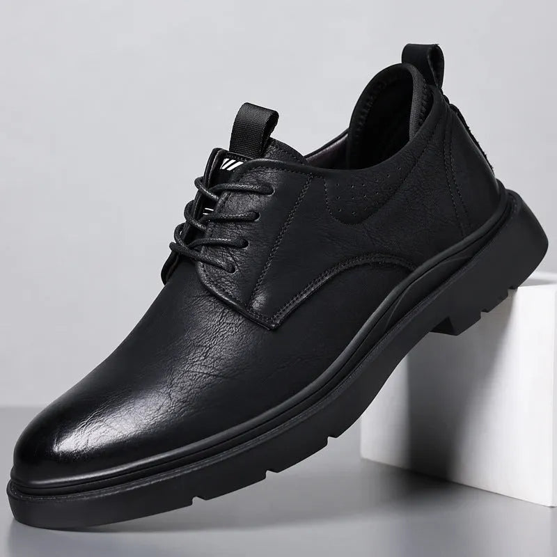 Men's black and brown cowhide leather sneaker shoes with rubber soles and decorative sewing lines.
