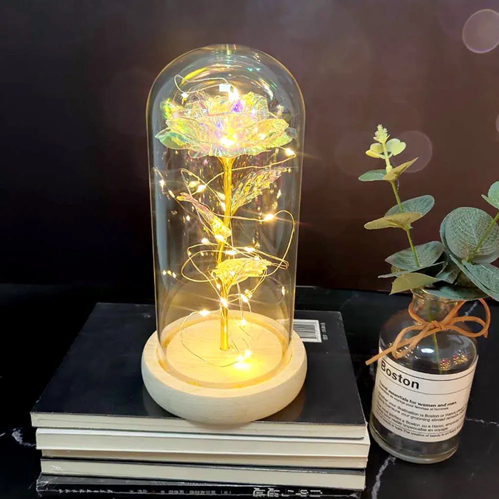 LED rose ornament with silk flowers under glass shade, showing colour options on a wooden base.