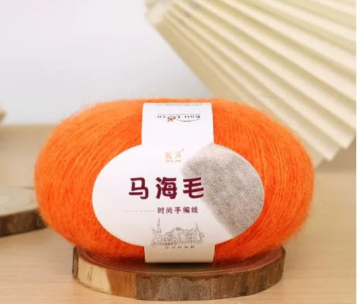 DIY mohair scarf weaving kit showing one wool ball and a selection of 34 colour options including white, pink, blue and green.