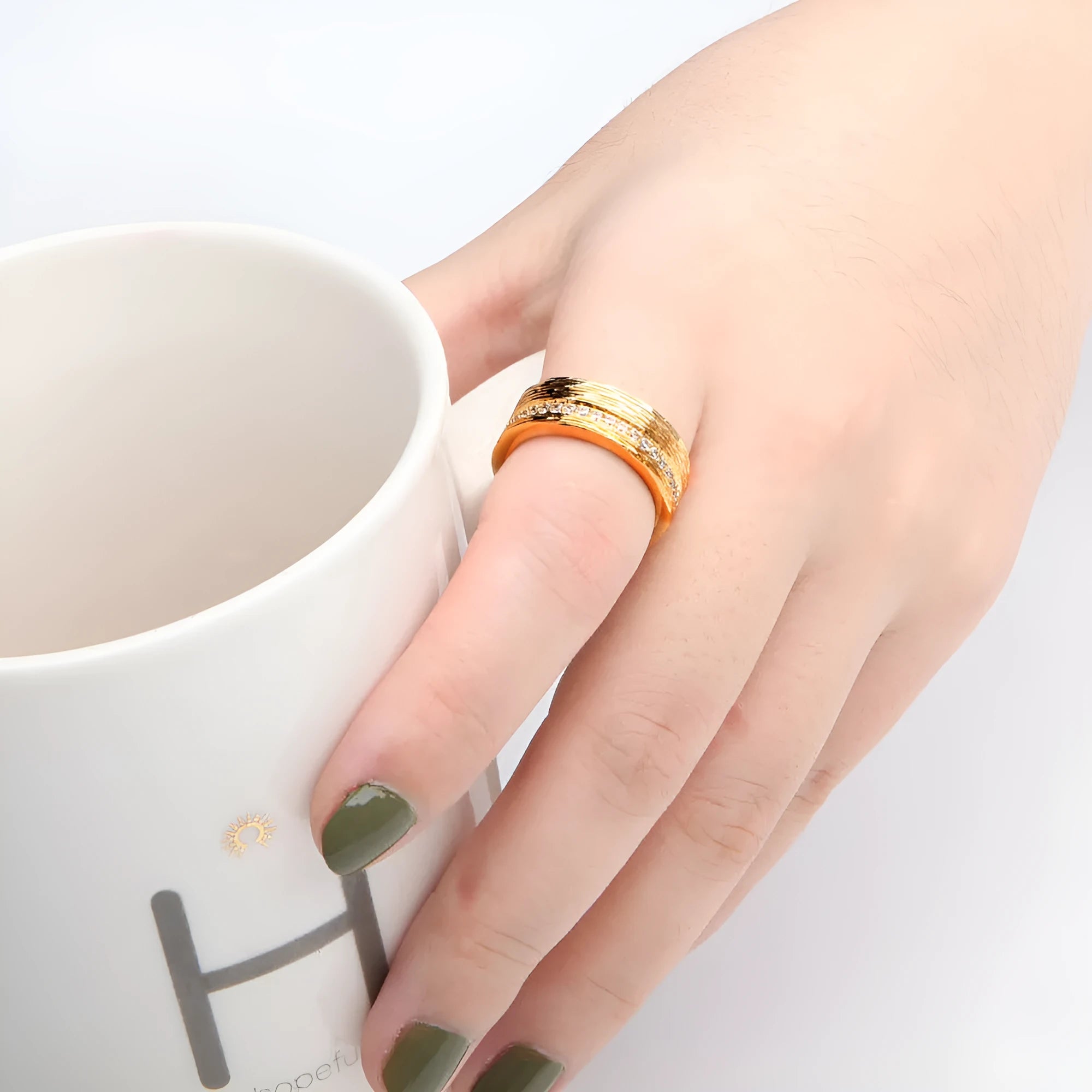 Gold-coloured geometric zircon ring for women showing openwork design and stone detail