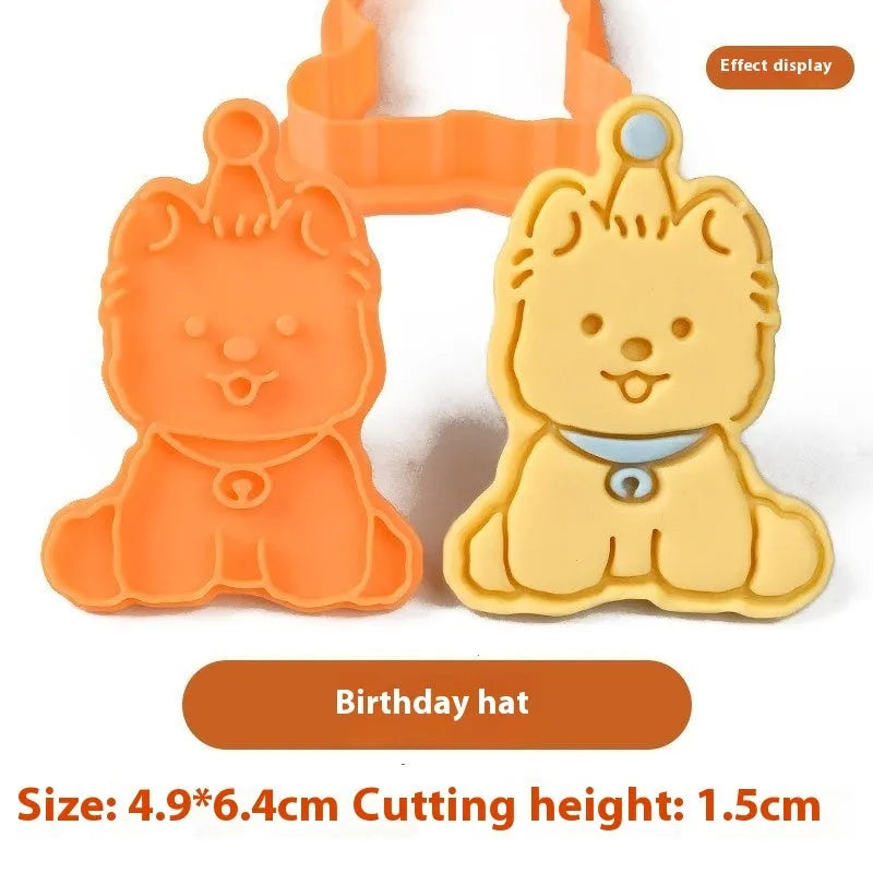 Three dimensional plastic biscuit mould showing puppy cartoon designs including birthday hats and swimming rings
