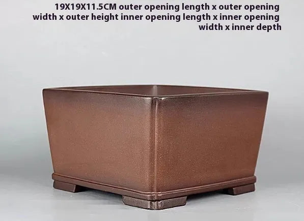 Brown handmade purple clay flower pot measuring 19cm wide with single drainage hole