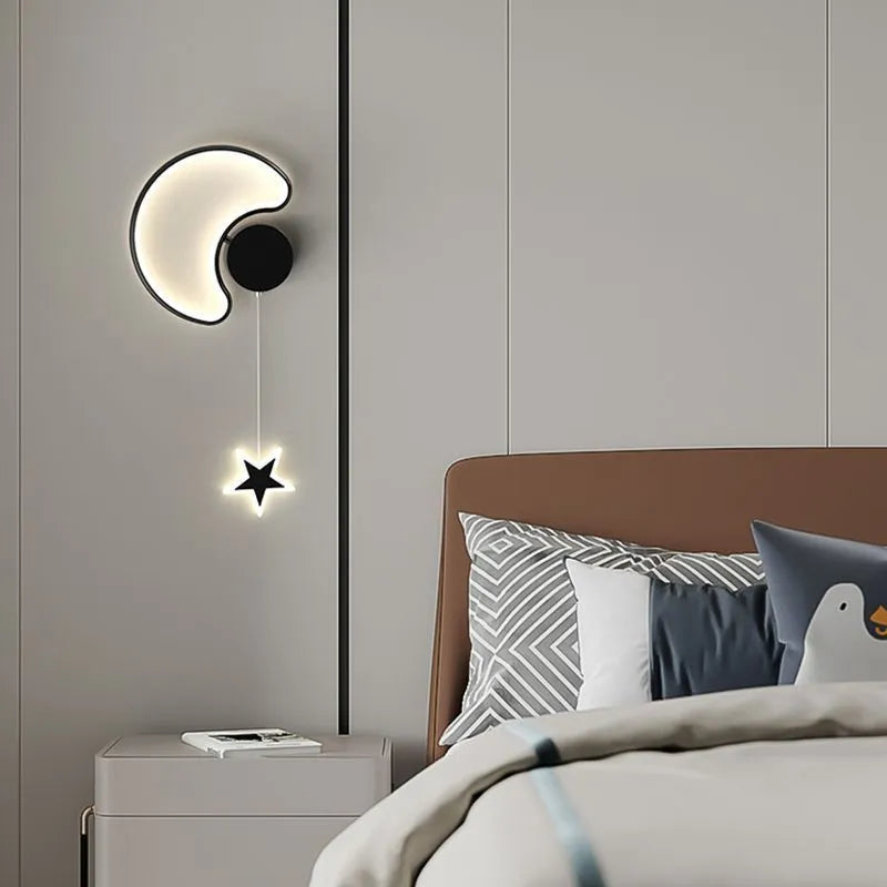 Children's bedside wall lamp with cloud and star design in black finish showing three-colour LED illumination
