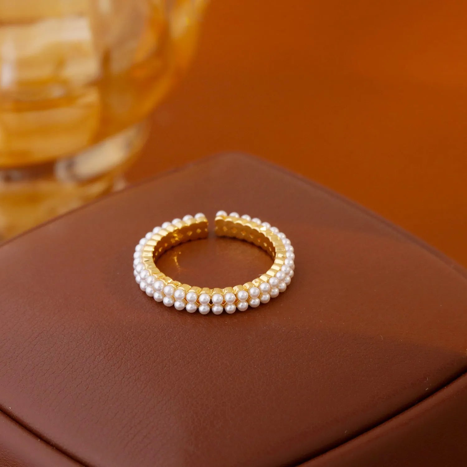 Gold geometric open-mouth women's ring with circular design elements on copper with electroplated finish