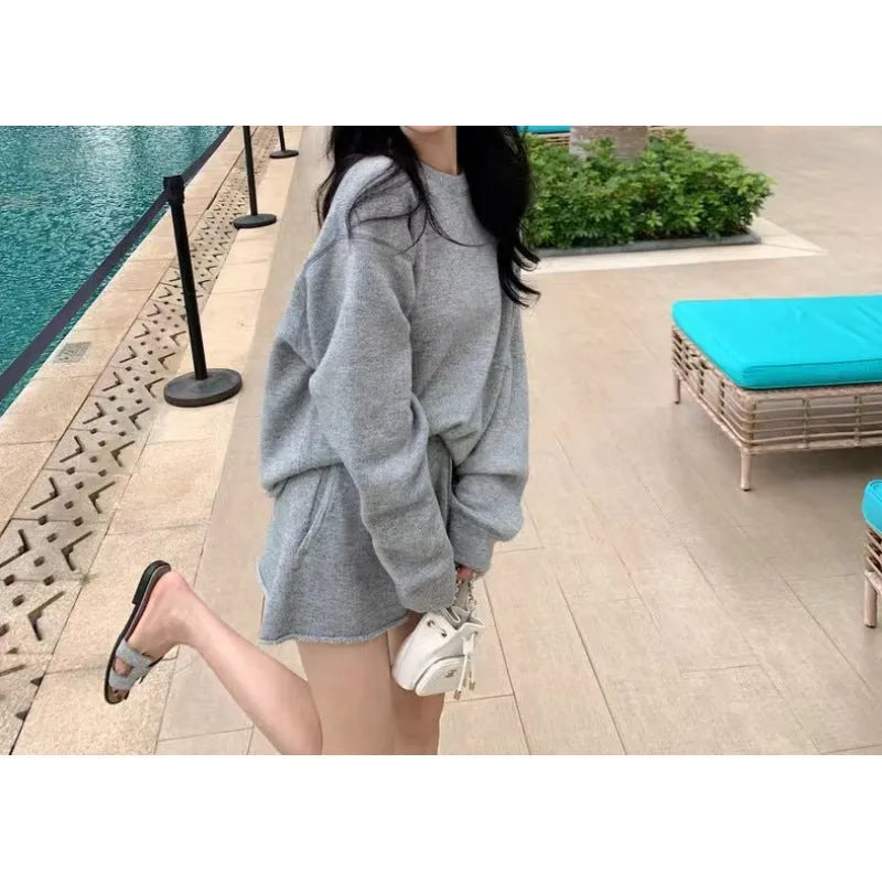Women's loose grey knitted sweater and wide leg shorts two-piece loungewear set.