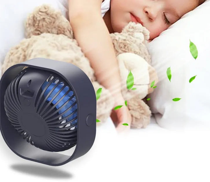 USB desk fan with rotating head in modern alarm clock style on a desk.