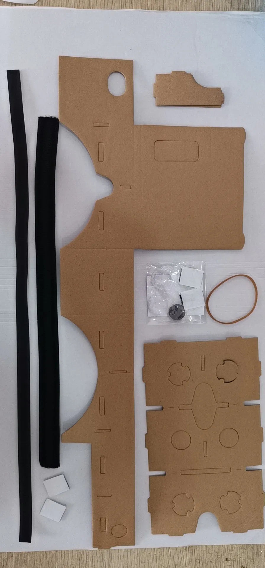 Pink cardboard VR glasses with rubber head strap and 3D lenses for smartphones