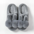 Women's fluffy bunny slippers in pink with rabbit fur, high-top sleeve design, and sewn sole.