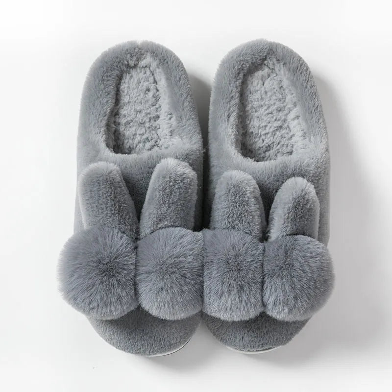Women's fluffy bunny slippers in pink with rabbit fur, high-top sleeve design, and sewn sole.