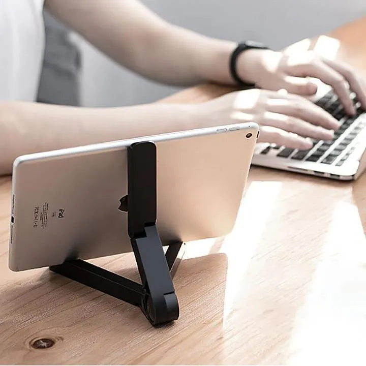 Black foldable tablet holder open in landscape mode holding a smartphone, showing side adjustment buttons.
