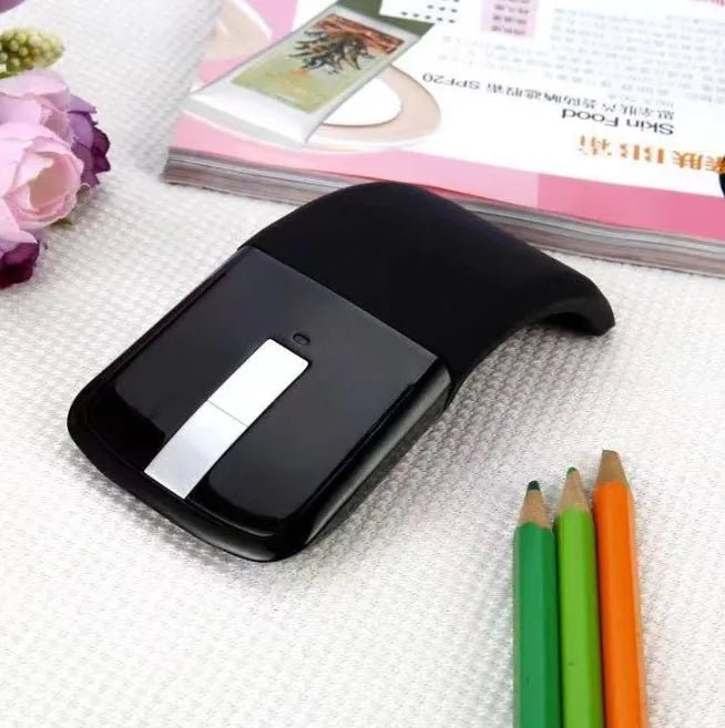 Folded Bluetooth wireless mouse showing compact 131.2mm length with touch surface and multiple colour options