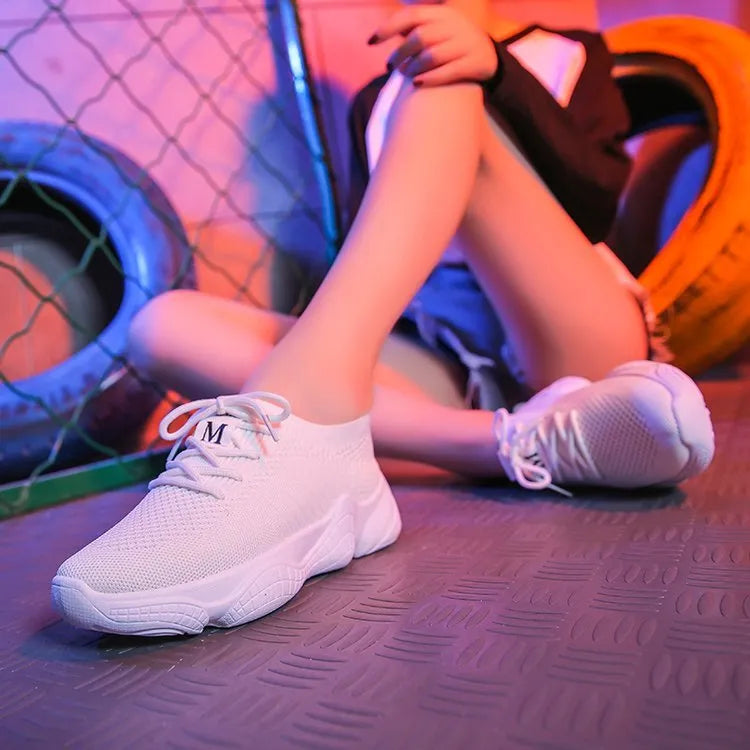 Women's white thick-soled casual sports shoes with woven upper and front strap.