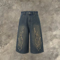 Men's black denim shorts with flame embroidery and cropped patch design on straight-leg cut