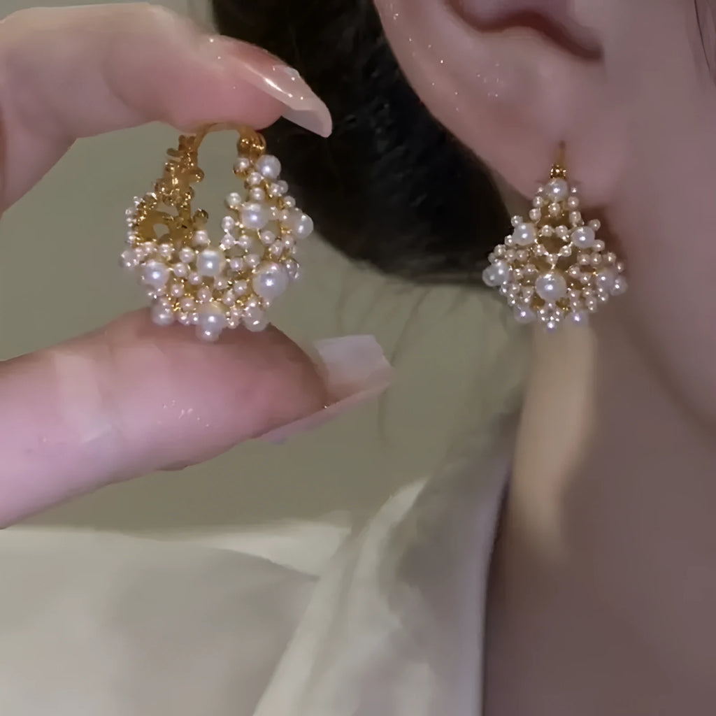 Gold-coloured copper earrings with a small bead flower basket design.