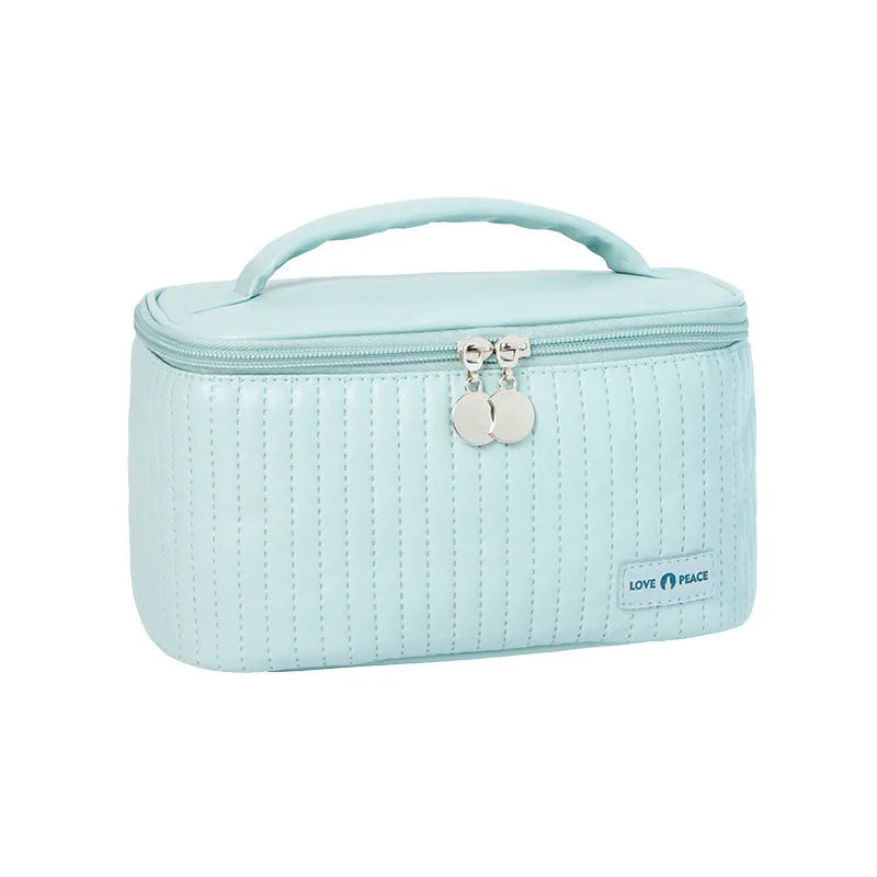 Open-top pink PU leather cake-style makeup bag on a table
