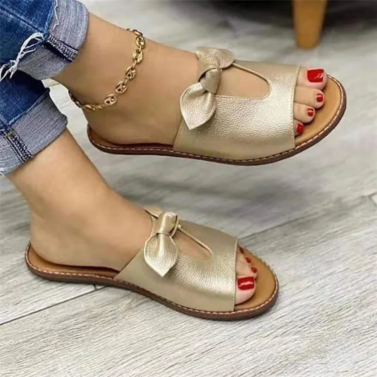 Ladies sandals with bow detail and fish mouth design in black, pink and gold colours