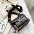 Vintage PU crossbody bag in black, shown with adjustable strap and open to reveal polyester lining.