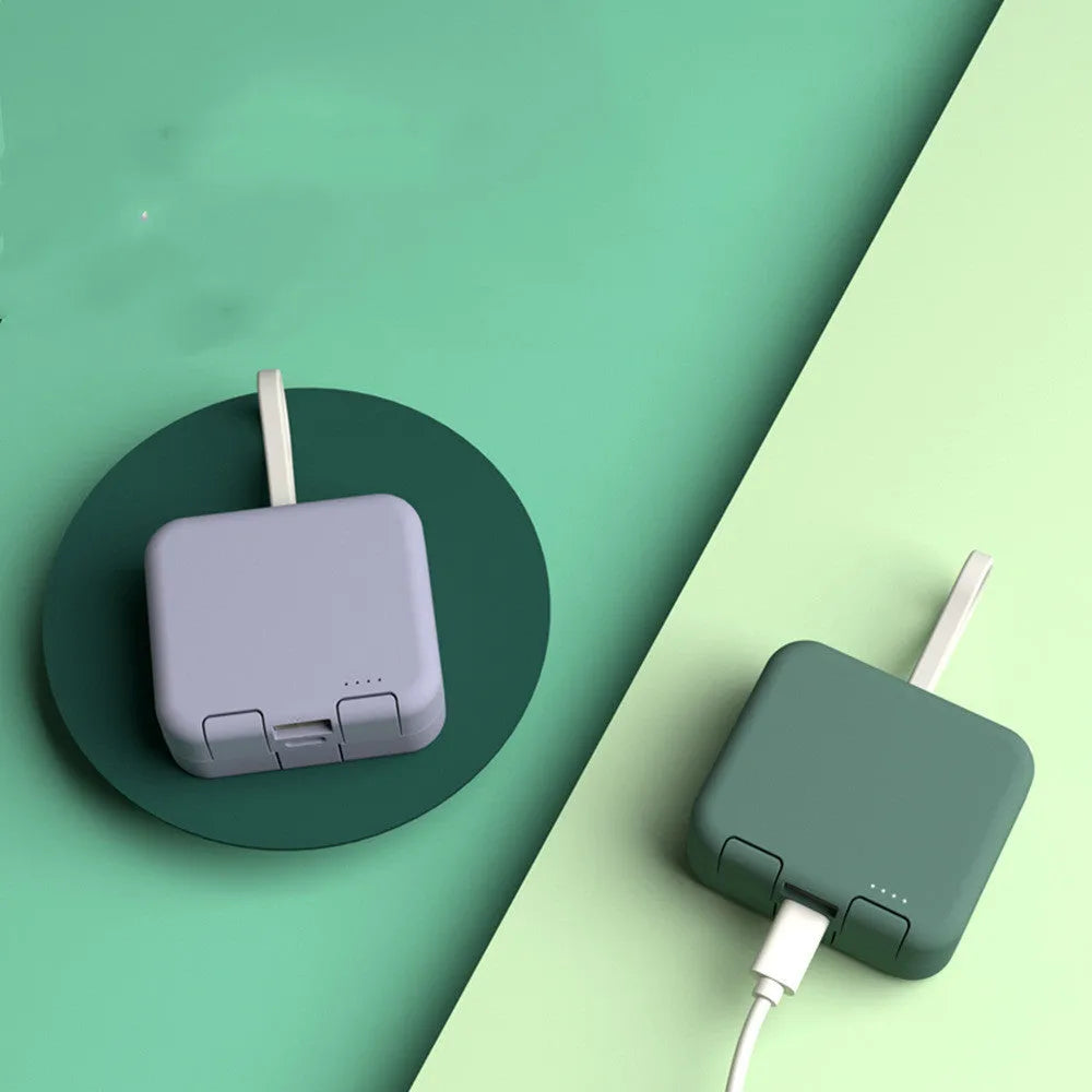 Handbag clip power bank in blue showing phone stand function with charging ports visible