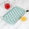 Blue silicone ice cube tray with lid showing 33 round moulds