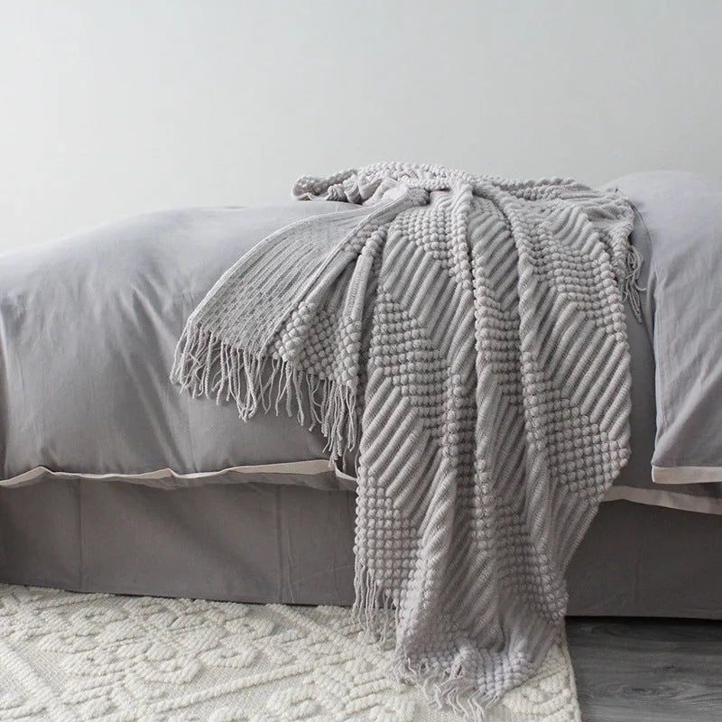 Small polyester fibre nap blanket measuring 127cm by 170cm in dark grey colour