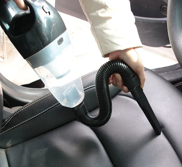 Orange, black, and blue portable handheld 12V car vacuum cleaner with nozzle attachments.