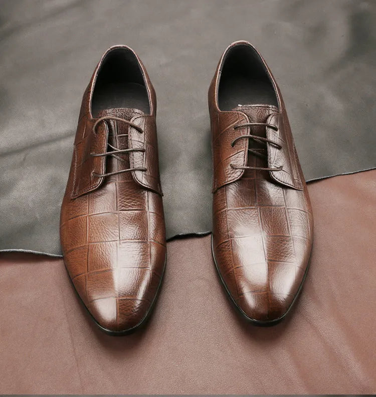 Men's black leather derby shoes with pointed toe and checkered pattern on a white background.