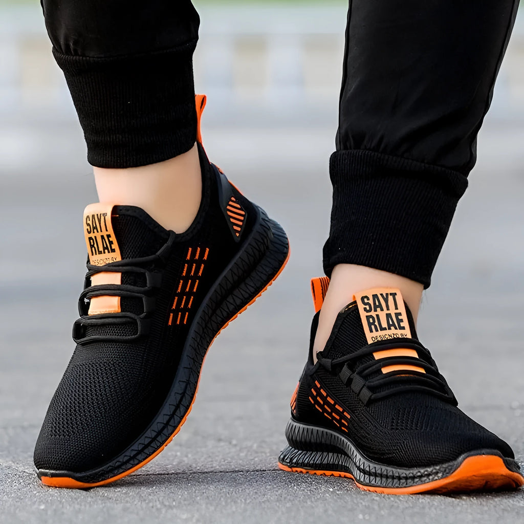 Men's black casual sports shoes with cross-strap detail and Flying Weave textured upper.