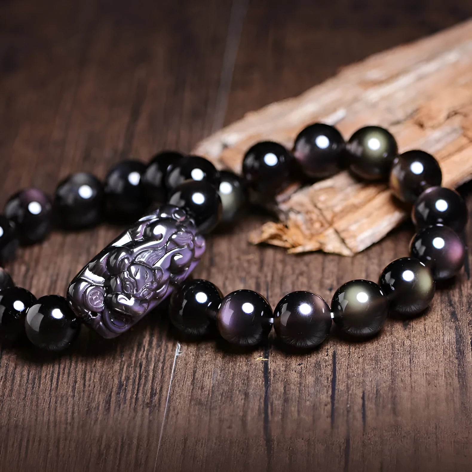 A geometric polished crystal bracelet featuring a Pi Xiu charm on a beaded strand.