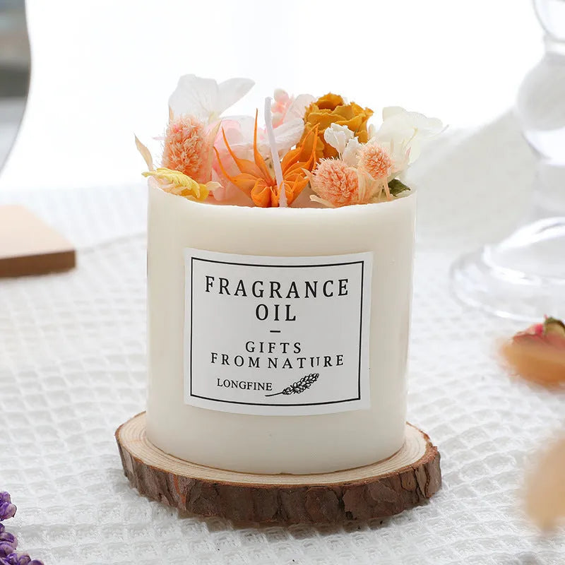 Decorative aromatherapy candle with dried flowers embedded in solid wax, shown with optional wooden chip base.