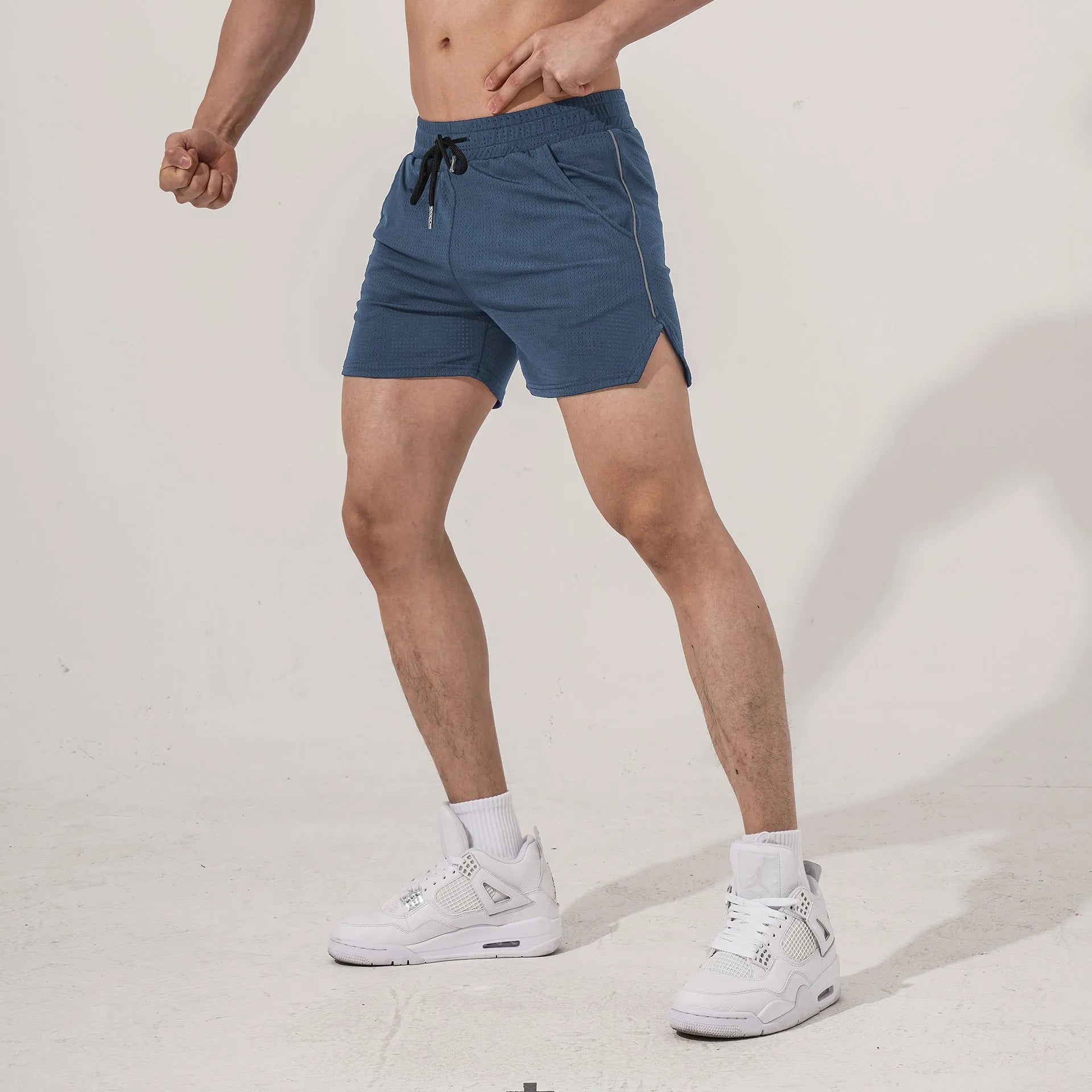Men's straight-fit polyester athletic shorts in black, grey, navy blue, or red for sports and fitness