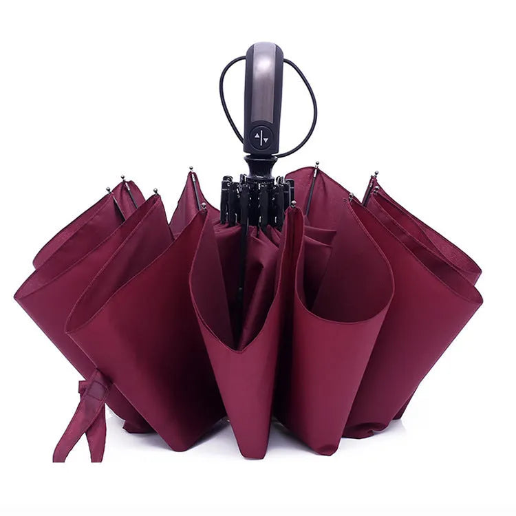 Large black triple folding automatic business umbrella with a steel frame and rubber handle, shown open.