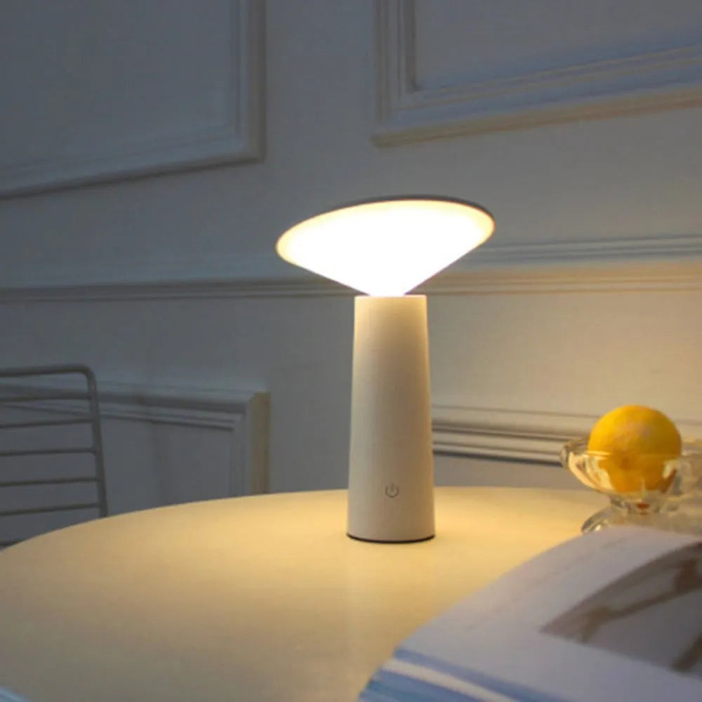 Black or white USB rechargeable LED desk lamp with a touch-sensitive base and a tilting lamp head.