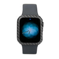 Ultra-thin black carbon fibre half-wrap case for a 44mm Apple Watch Series 4 on a leather band.