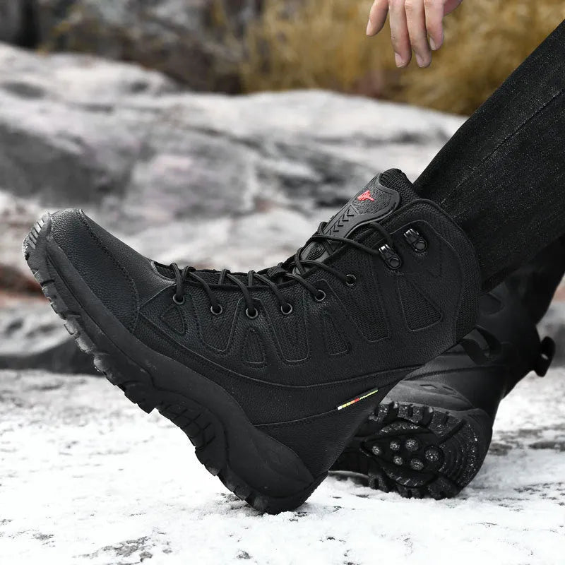 Men's brown cowhide leather hi-top hiking shoes with a platform sole on a rocky outdoor trail.