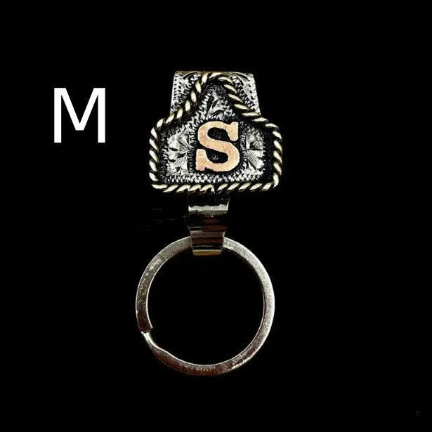 Handmade metal cow tag belt key holder keychain on a key ring, showing the metal loop and tag design.