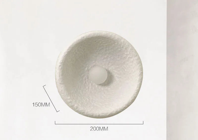Japanese-style minimalist wall lamp with resin shade in three diameter options on modern interior wall