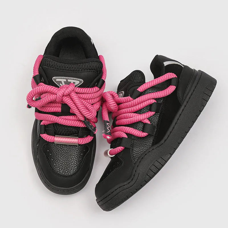 Pair of thick-soled casual lace-up shoes in a solid colour on a white background.