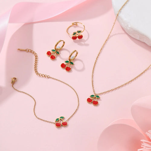 Cherry jewellery set showing necklace, bracelet, earrings, and ring with stainless steel construction and cherry fruit design