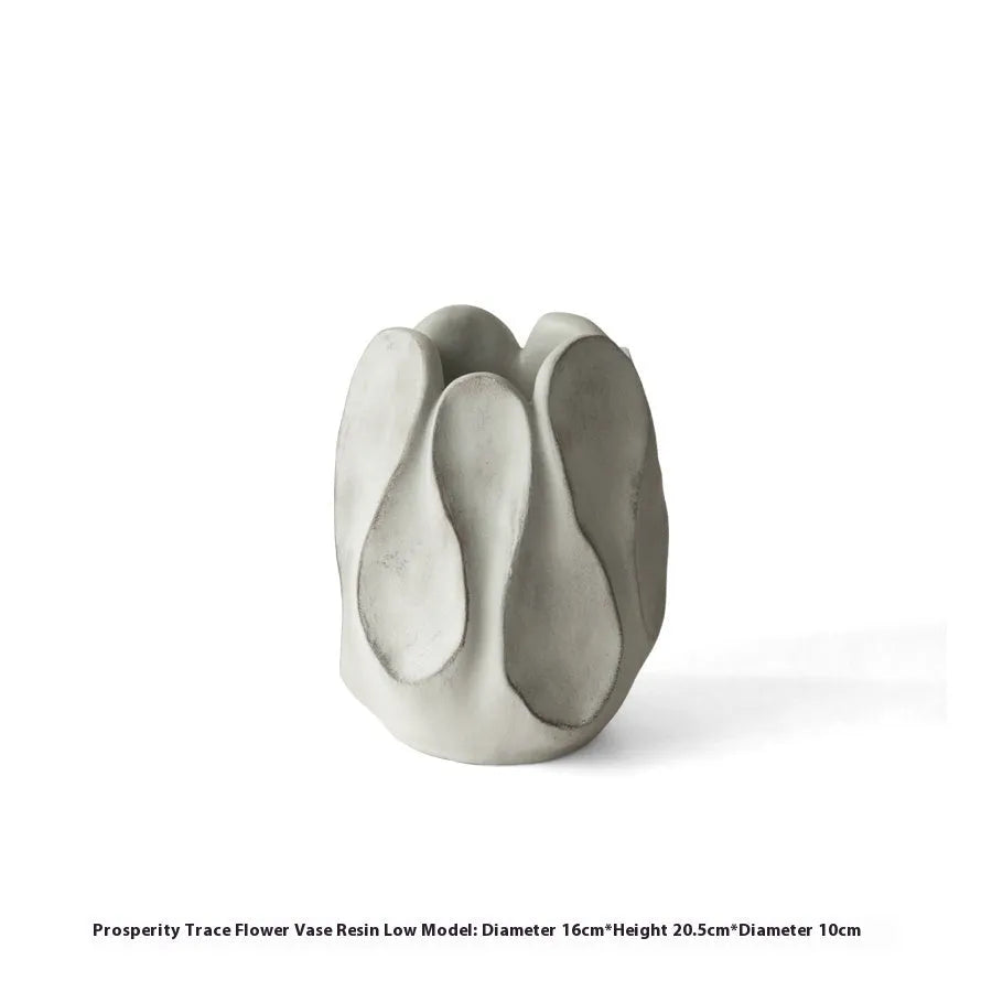 Handmade irregular ceramic vase in magnesium clay on a wooden surface.