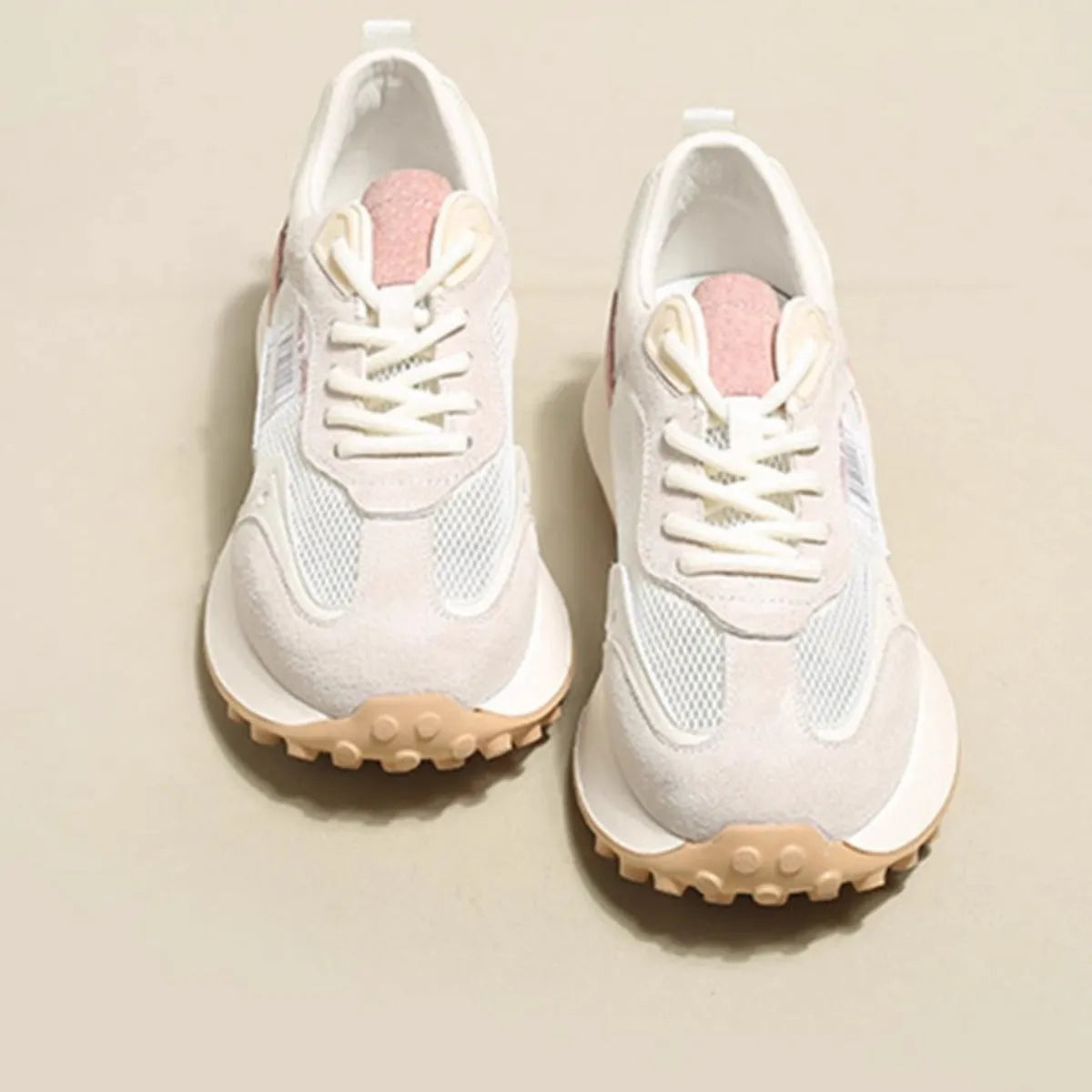 Women's grey and pink retro sneakers with mesh lining, rubber sole, and round toe design