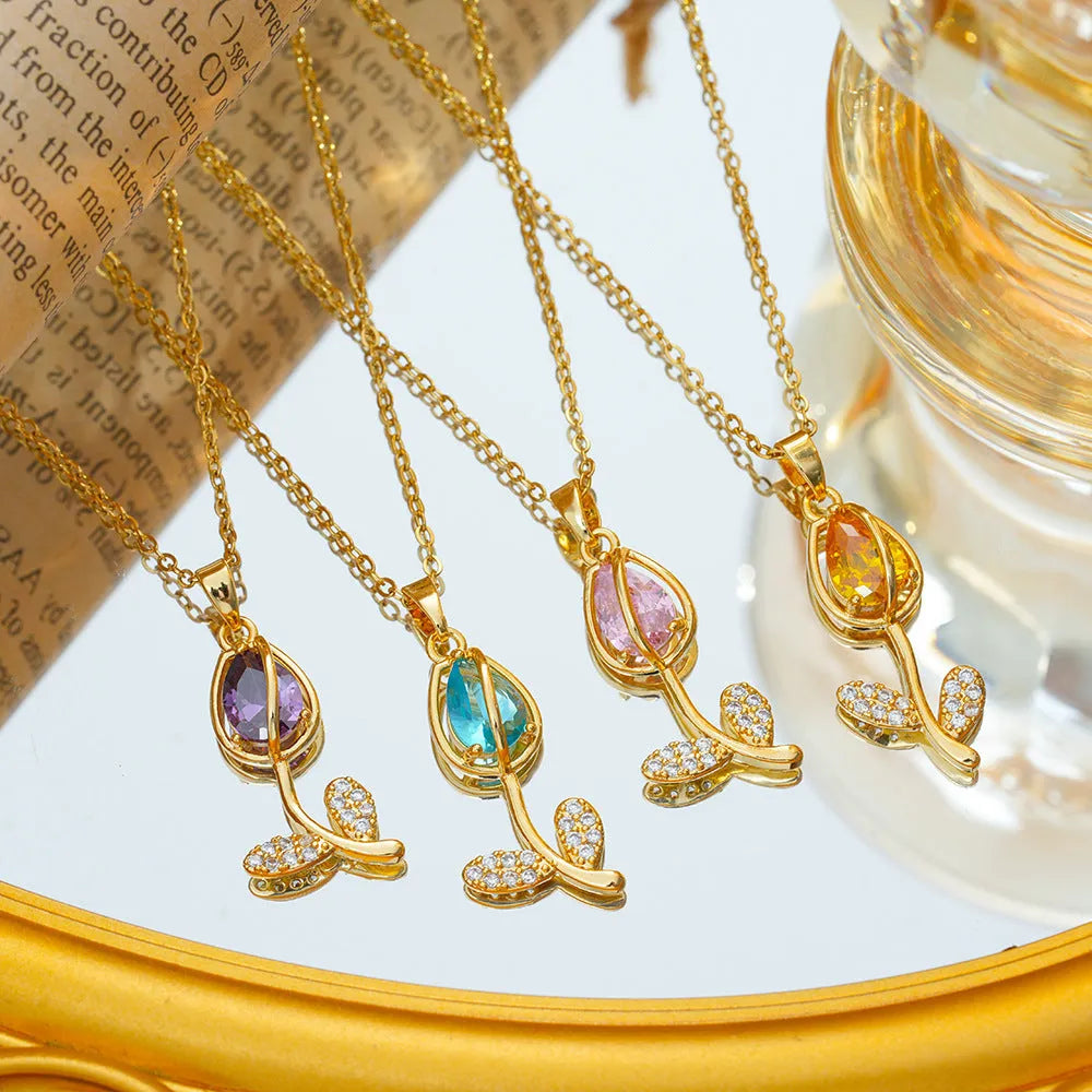 Gold electroplated tulip flower pendant on an adjustable titanium steel necklace chain.