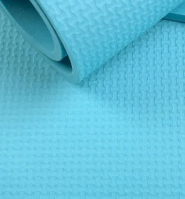 Red EVA yoga mat with textured anti-skid surface, shown rolled and unrolled.