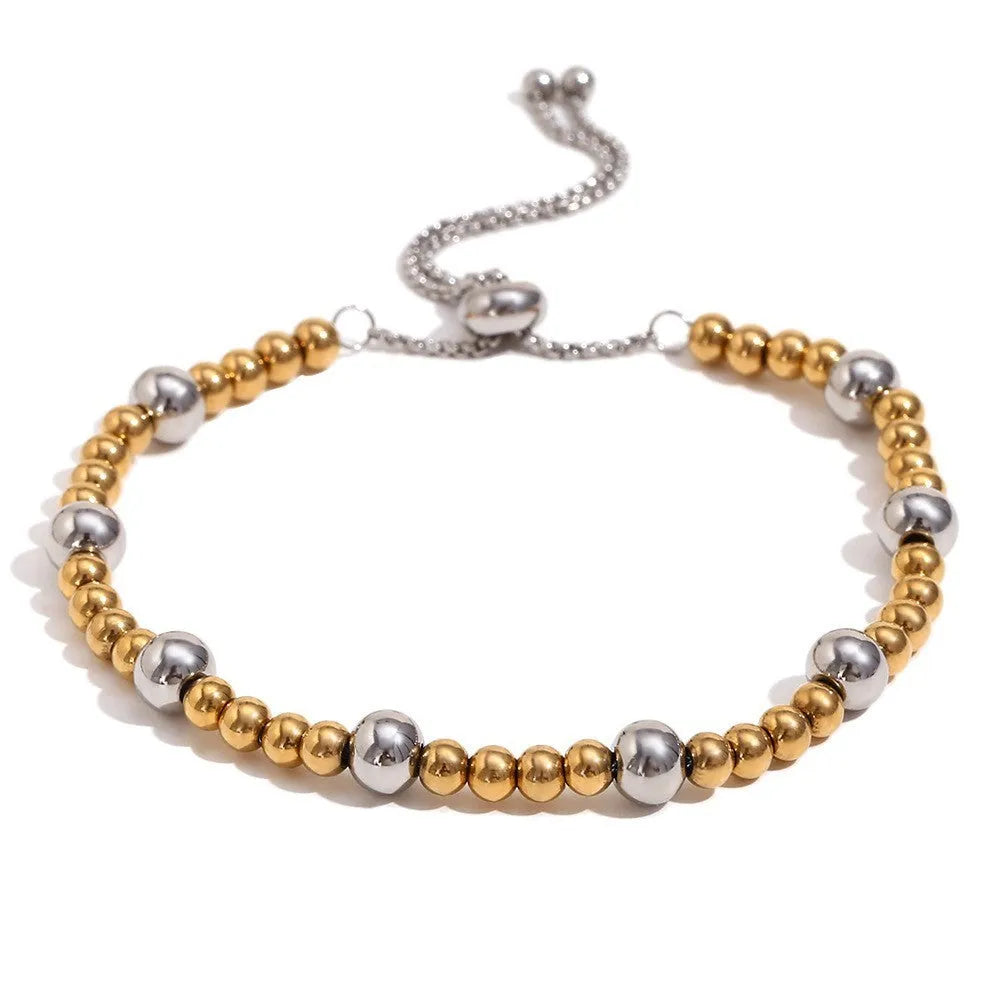 Gold electroplated geometric jewellery set with earrings, bracelet, and necklace on stainless steel